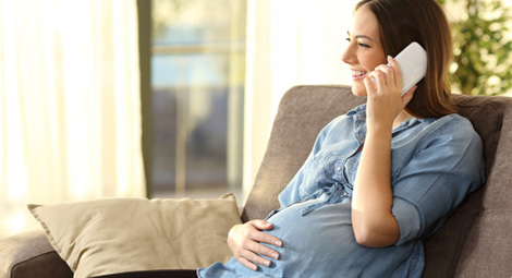 A pregnant woman on the telephone